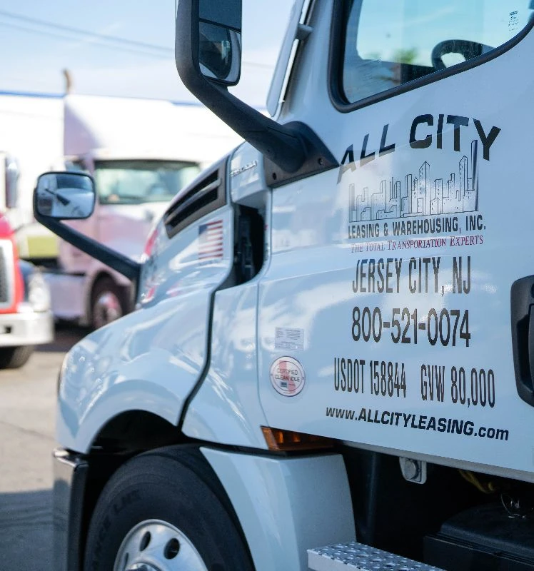 Close-up of All City truck door showing contact number, USDOT info, and Jersey City, NJ location for All City Leasing & Warehousing services