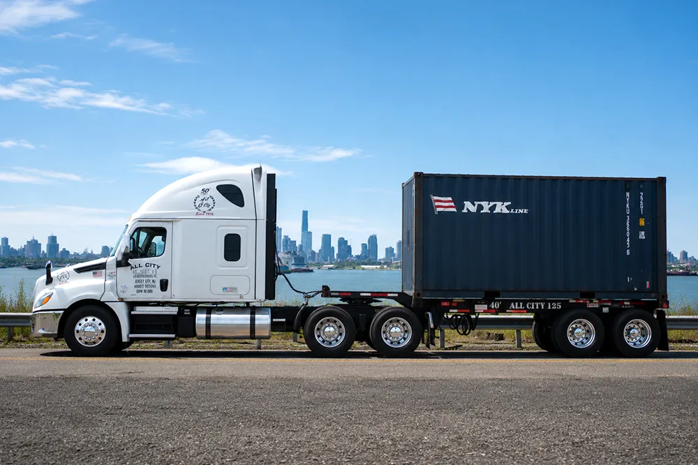 All City Leasing container truck on a waterfront road